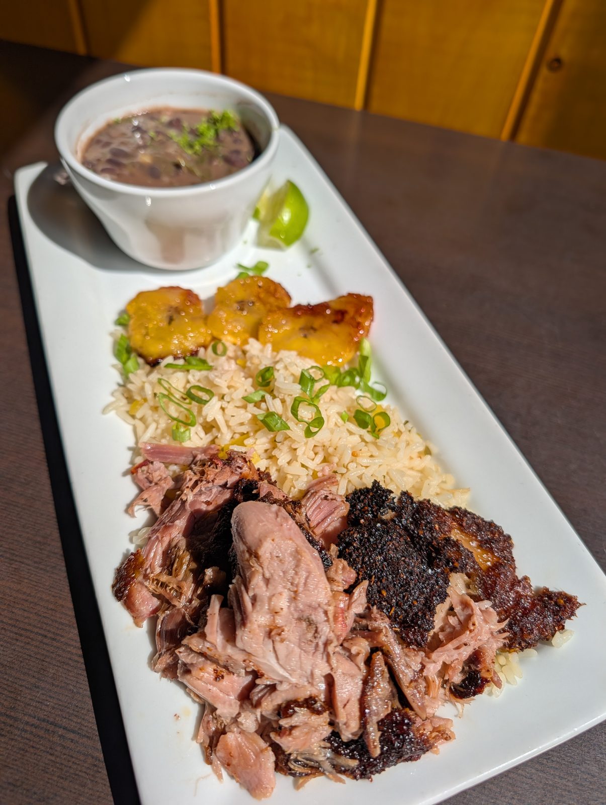 Mojo pulled pork with rice, sweet plantains, and a cup of black beans