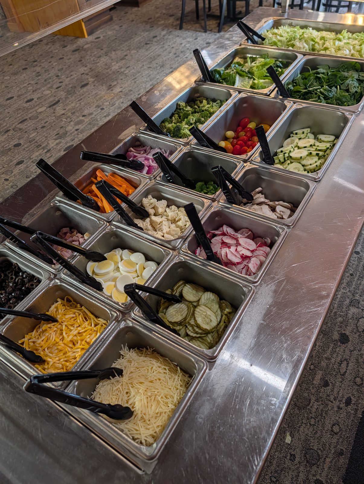 The salad bar, loaded with fresh-cut vegetables, cheeses, and toppings